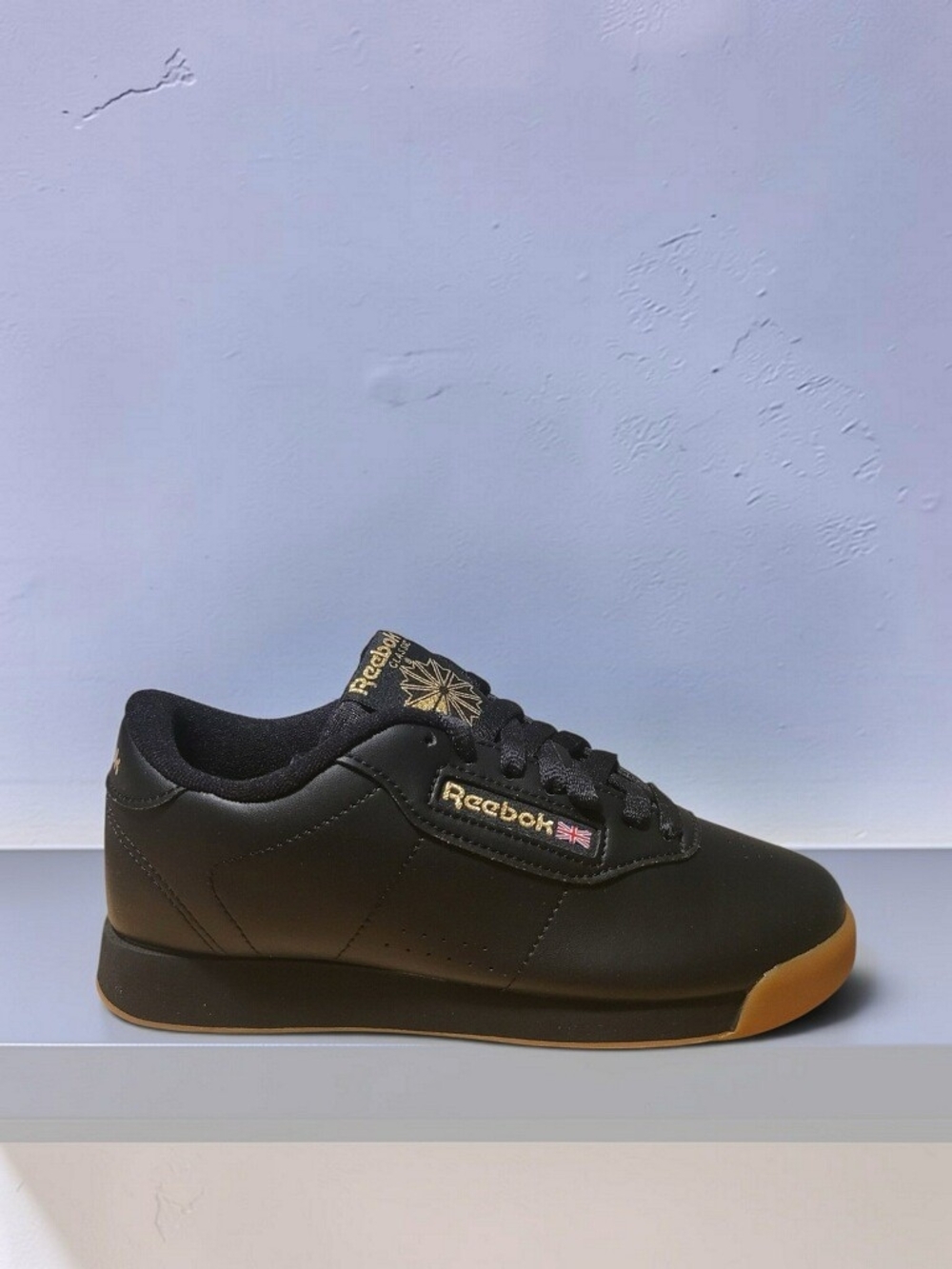 Reebok Women’s Black Leather Sneaker with Gum Toe and Sole